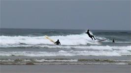 Surfers enjoy the waves at Perranporth Beach